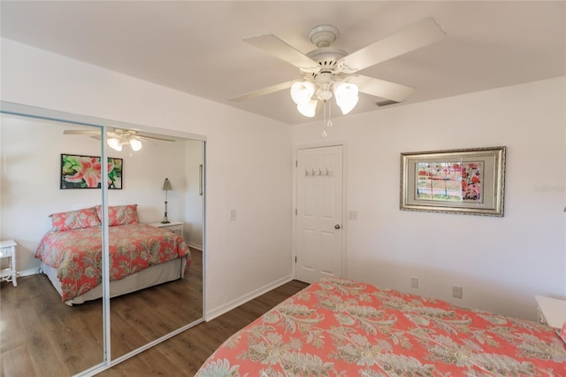 bedroom featuring ceiling fan, a closet, and dark wood-type flooring