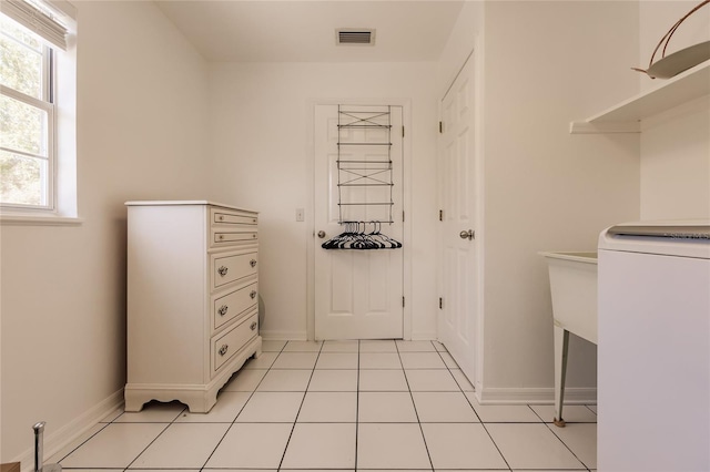 washroom featuring washer / clothes dryer and light tile patterned floors