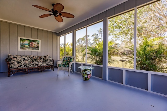 unfurnished sunroom featuring ceiling fan