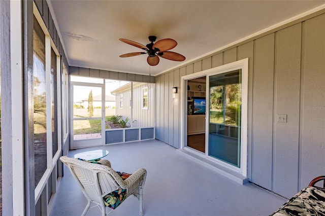 unfurnished sunroom with ceiling fan