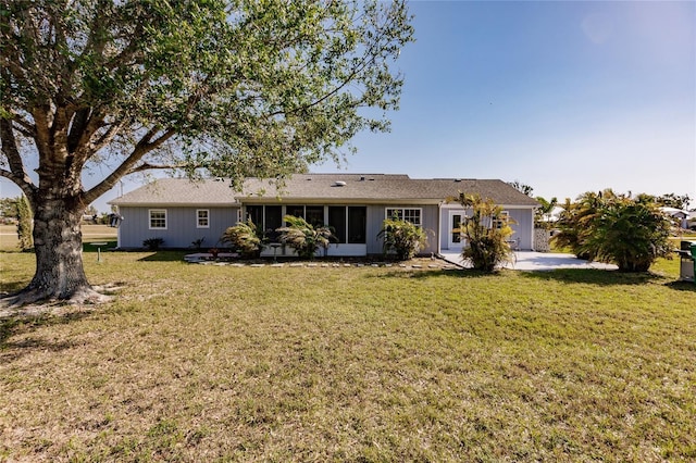 rear view of house featuring a lawn