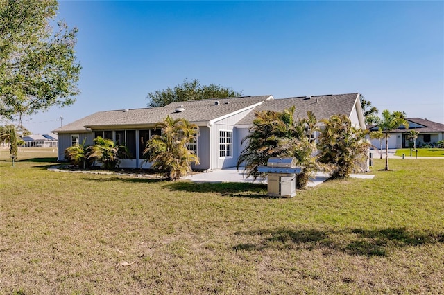 rear view of house with a lawn