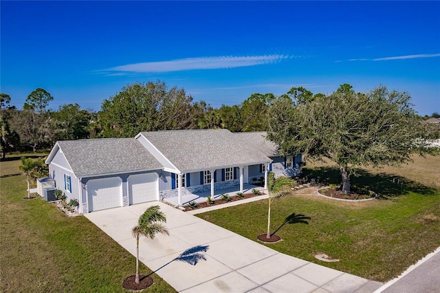 ranch-style home with a front yard, covered porch, a garage, and central AC