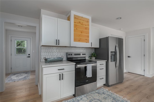 kitchen featuring decorative backsplash, light hardwood / wood-style flooring, white cabinets, and appliances with stainless steel finishes