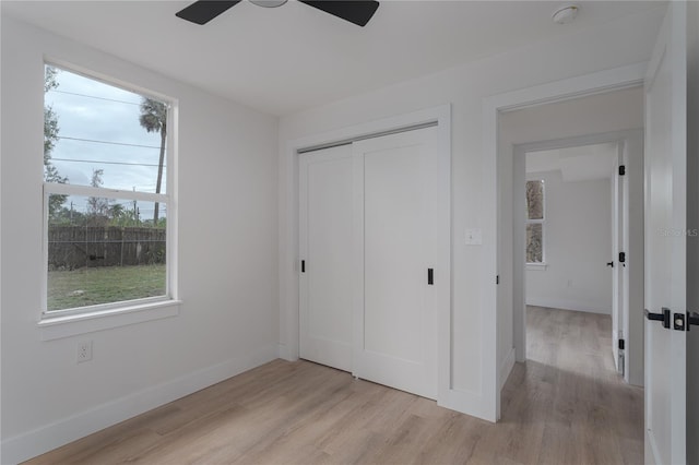 unfurnished bedroom with a closet, ceiling fan, and light hardwood / wood-style flooring