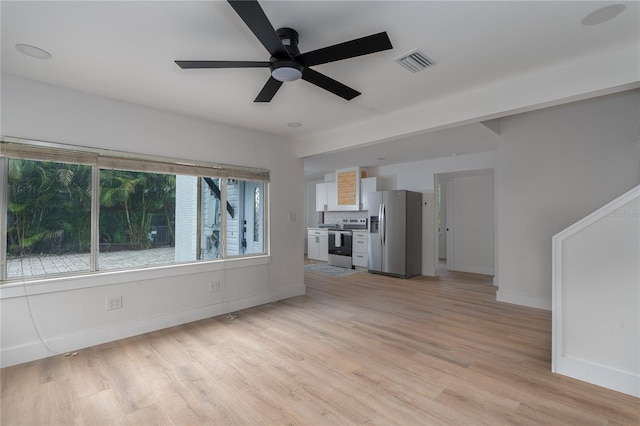 unfurnished living room featuring ceiling fan and light hardwood / wood-style floors