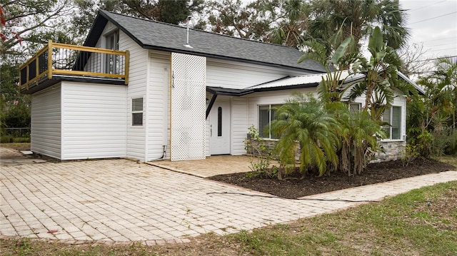 back of house with a balcony