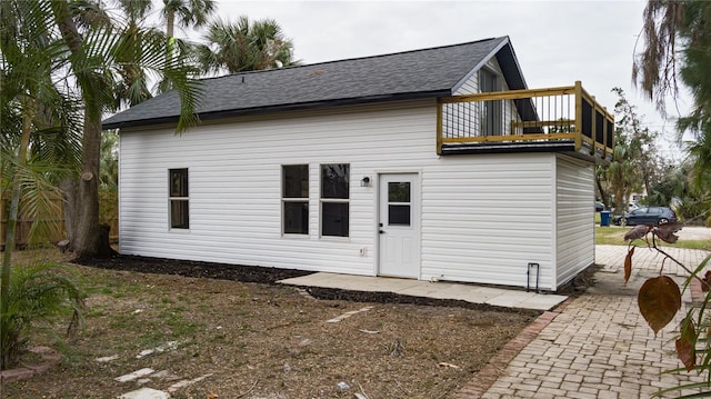 rear view of house featuring a balcony