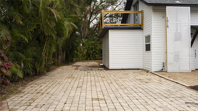 view of property exterior featuring a balcony and a patio area