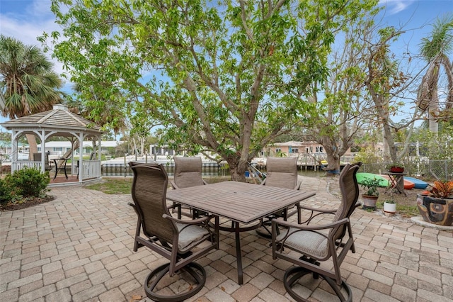 view of patio featuring a gazebo and a water view