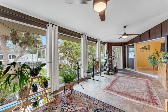 sunroom featuring vaulted ceiling and ceiling fan