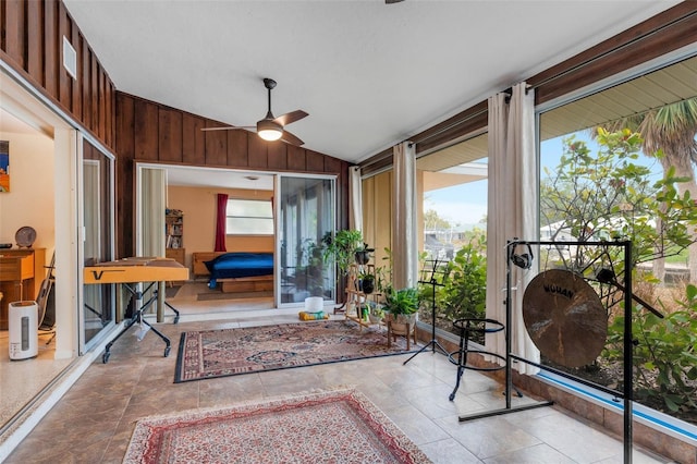 sunroom / solarium with lofted ceiling and ceiling fan