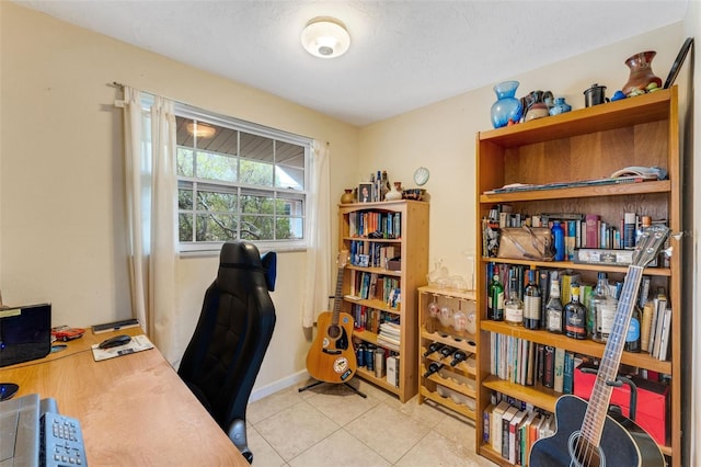 tiled home office featuring a textured ceiling