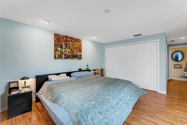 bedroom featuring light wood-type flooring and a closet