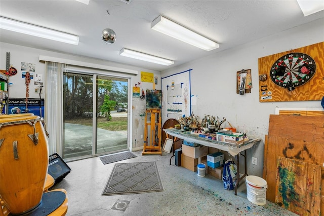 misc room with concrete flooring and a workshop area