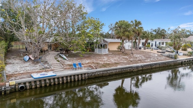 rear view of house featuring a water view