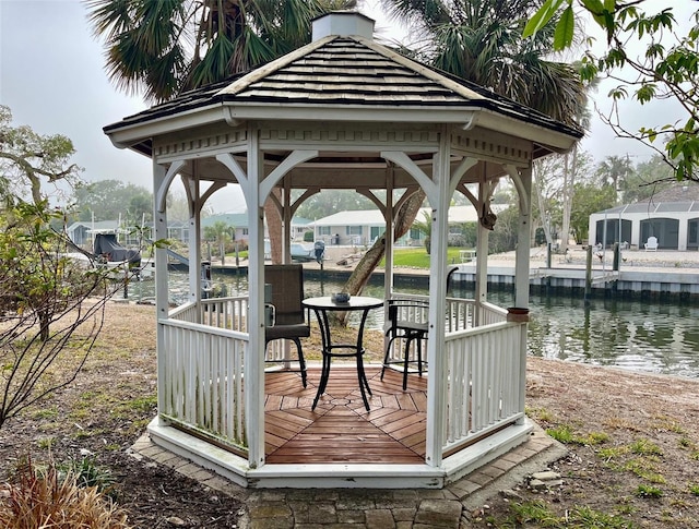 view of dock with a gazebo and a water view