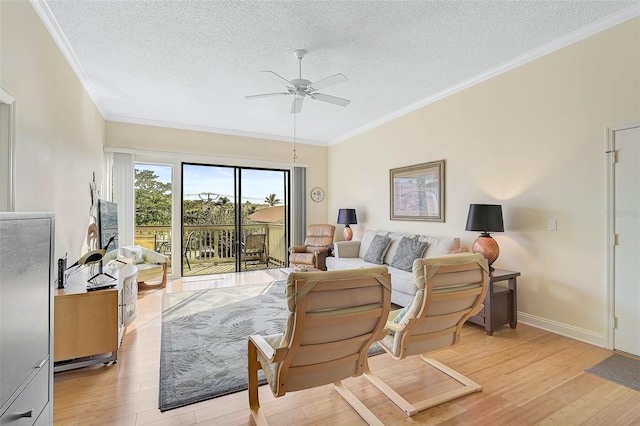 living room featuring a textured ceiling, light hardwood / wood-style flooring, ceiling fan, and crown molding