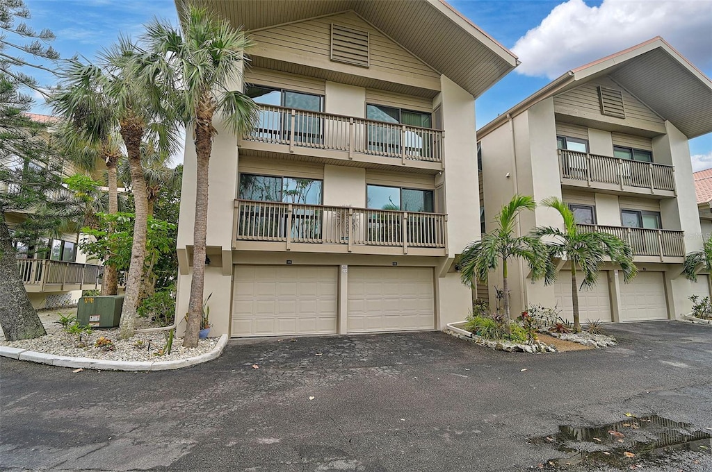 view of front of property featuring a garage and central AC