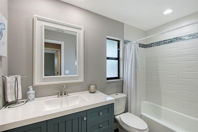 full bathroom with vanity, toilet, and shower / tub combo with curtain