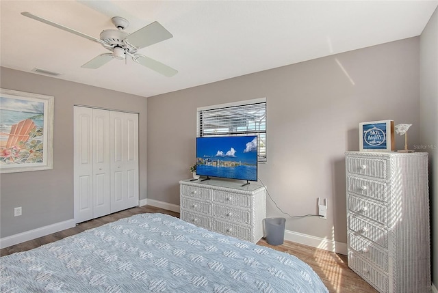 bedroom with hardwood / wood-style flooring, a closet, and ceiling fan