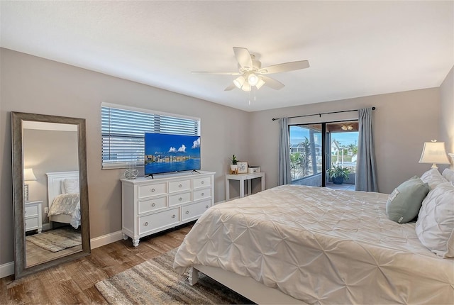 bedroom featuring access to outside, ceiling fan, and dark hardwood / wood-style floors