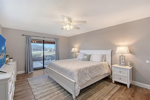 bedroom featuring hardwood / wood-style flooring, ceiling fan, and access to outside