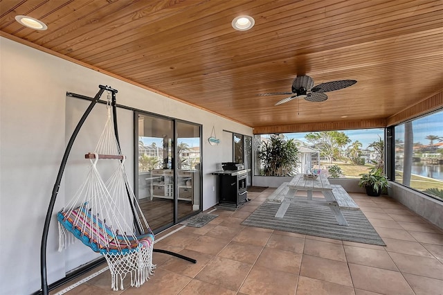 view of patio / terrace with ceiling fan and a water view