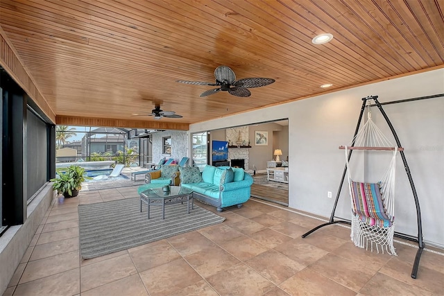 view of patio with outdoor lounge area, ceiling fan, and a lanai