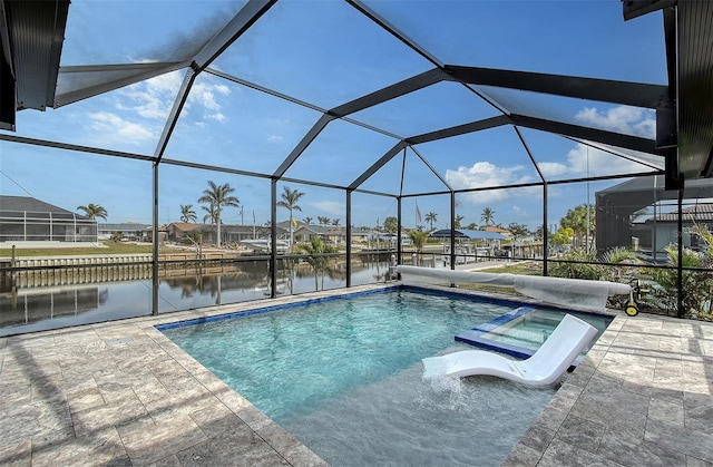 view of swimming pool with a lanai, an in ground hot tub, a water view, and a patio