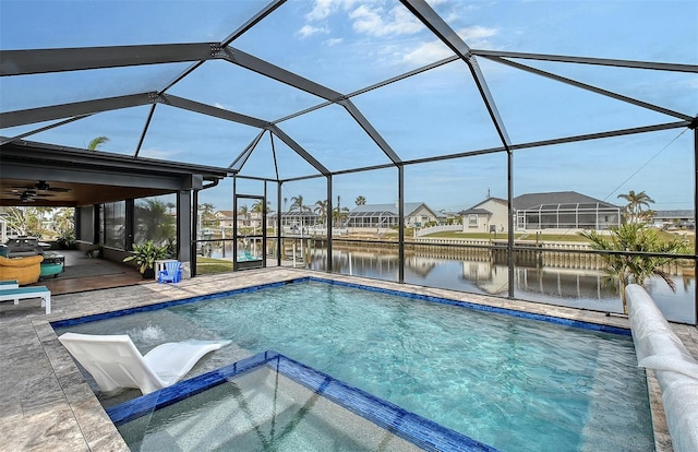 view of swimming pool featuring a lanai, ceiling fan, a water view, and a patio