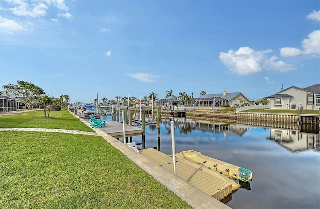 dock area featuring a lawn and a water view