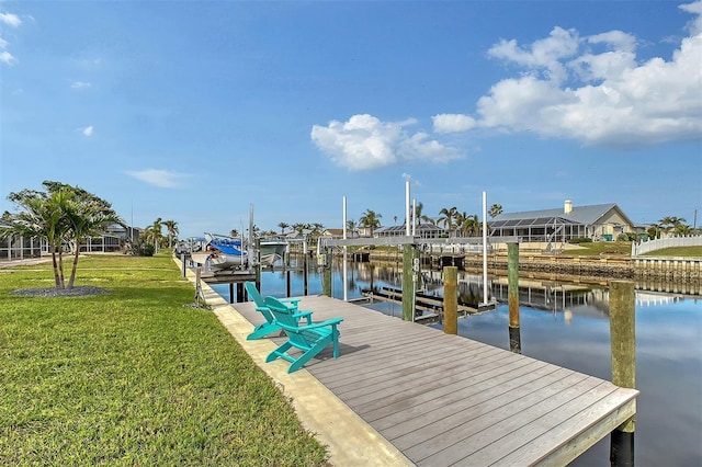 view of dock featuring a lawn and a water view