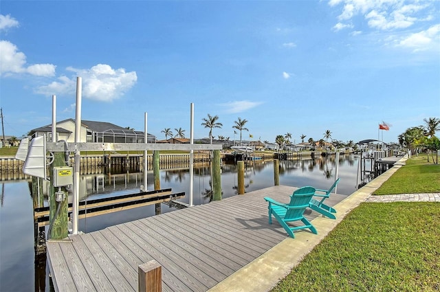 dock area with a yard and a water view