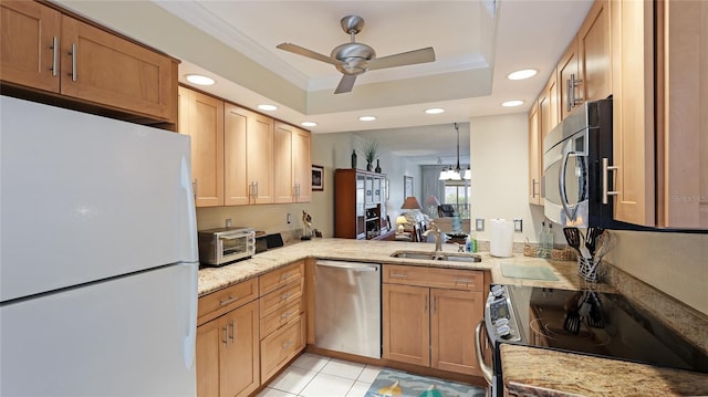 kitchen featuring sink, kitchen peninsula, a tray ceiling, light tile patterned floors, and appliances with stainless steel finishes