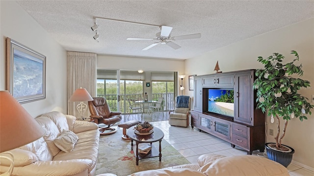 tiled living room featuring a textured ceiling, track lighting, and ceiling fan