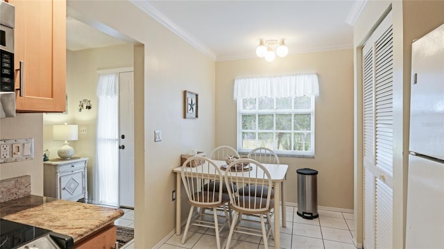 dining room featuring light tile patterned floors and ornamental molding