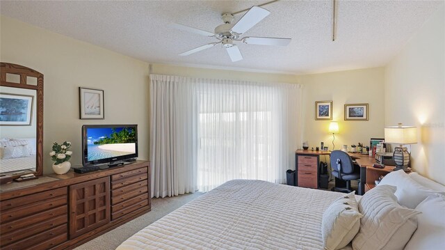 carpeted bedroom with a textured ceiling and ceiling fan