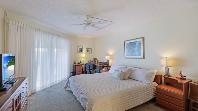 bedroom featuring carpet, ceiling fan, and a textured ceiling