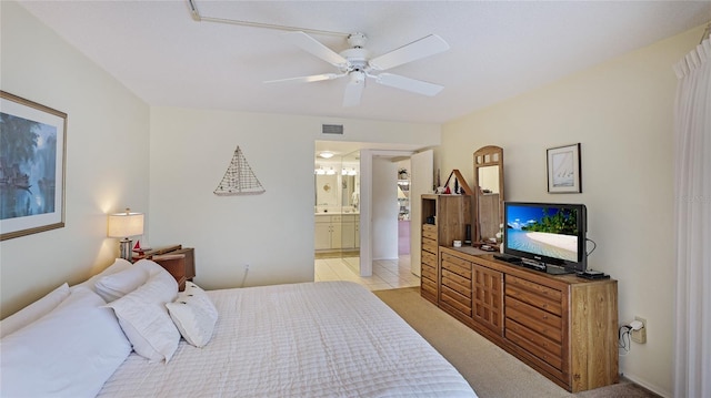 bedroom featuring ceiling fan and ensuite bathroom