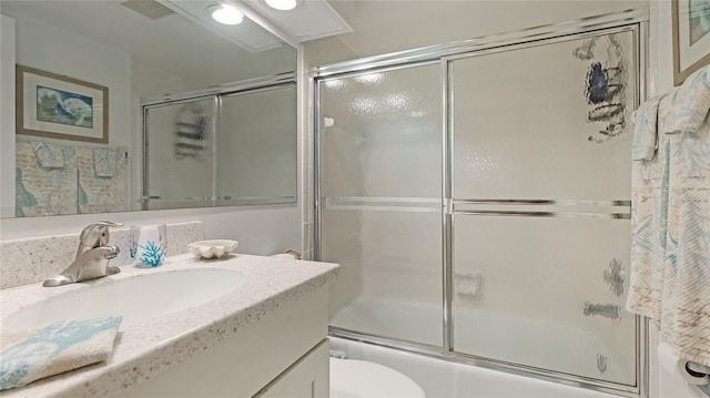 full bathroom with vanity, toilet, and enclosed tub / shower combo