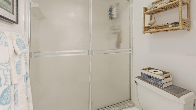 bathroom featuring toilet and walk in shower