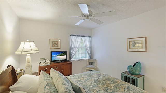 bedroom with a textured ceiling and ceiling fan