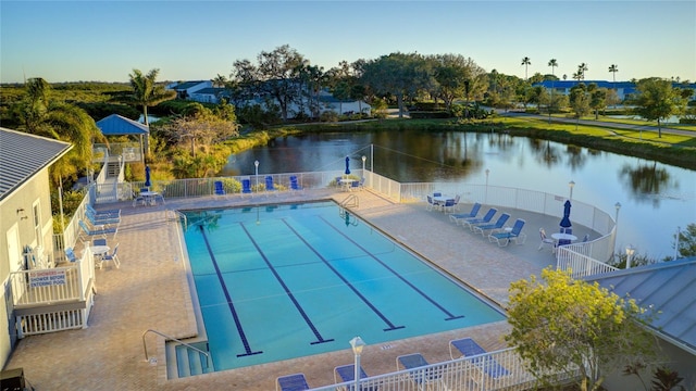 view of swimming pool featuring a patio area and a water view