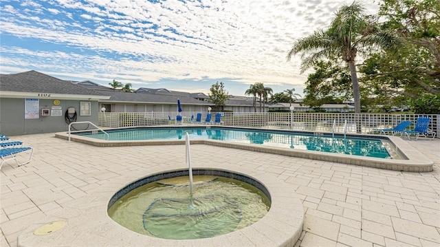 view of swimming pool with a community hot tub and a patio