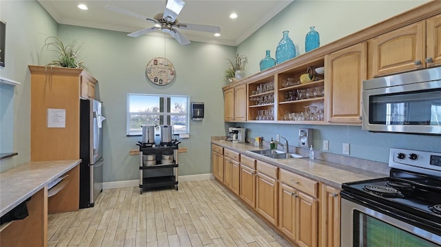 kitchen with ceiling fan, sink, ornamental molding, and stainless steel appliances