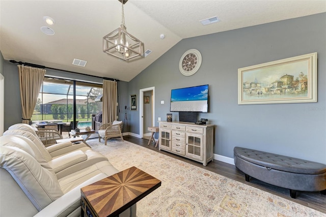 living room featuring an inviting chandelier, dark hardwood / wood-style flooring, and vaulted ceiling