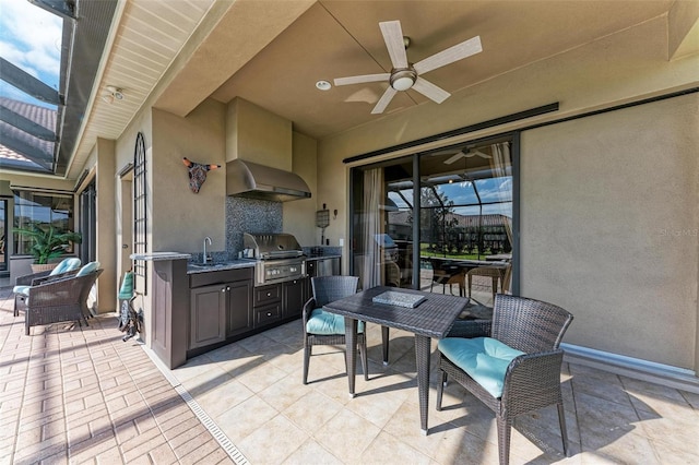 view of patio with exterior kitchen, a grill, sink, and ceiling fan