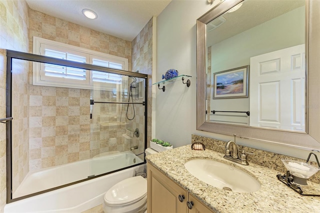 full bathroom with vanity, enclosed tub / shower combo, and toilet