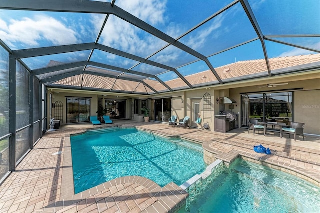 view of pool featuring ceiling fan, area for grilling, glass enclosure, and a patio